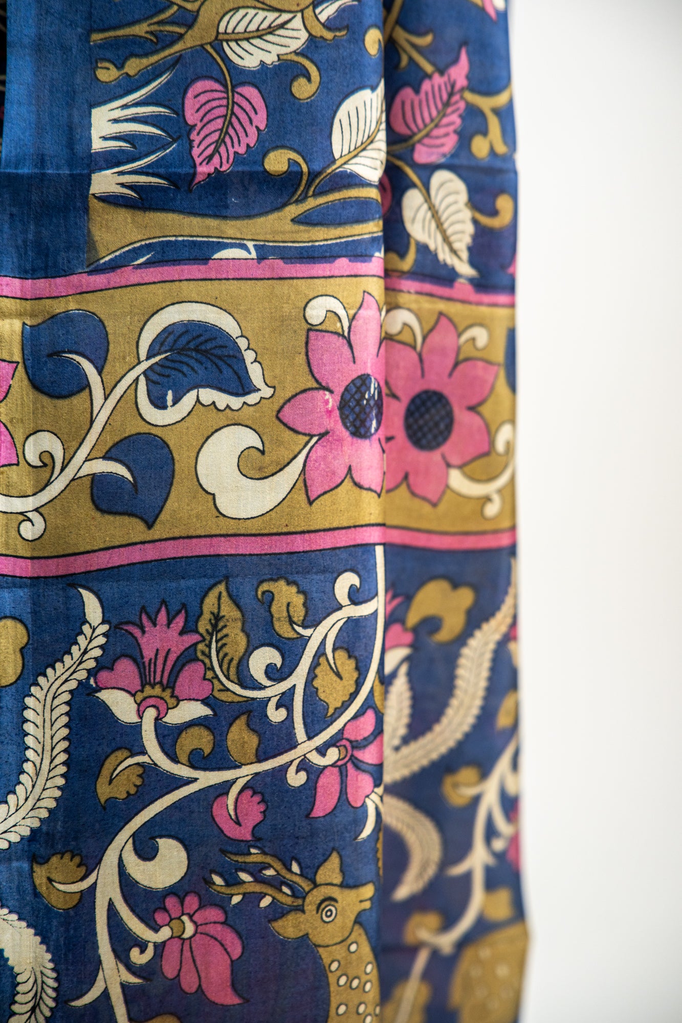 Royal Midnight Blue base adorned with Sage Green, Cream, and soft Coral Pink Pure Silk Saree