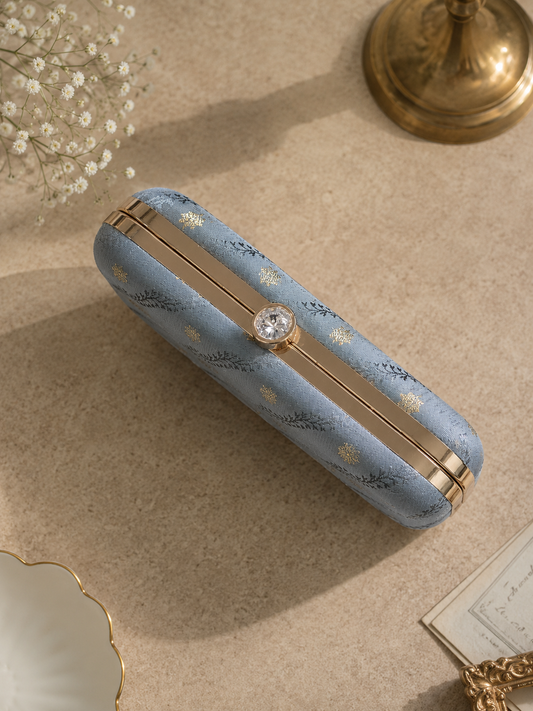 grey brocade clutch bag with gold detailing and chain strap