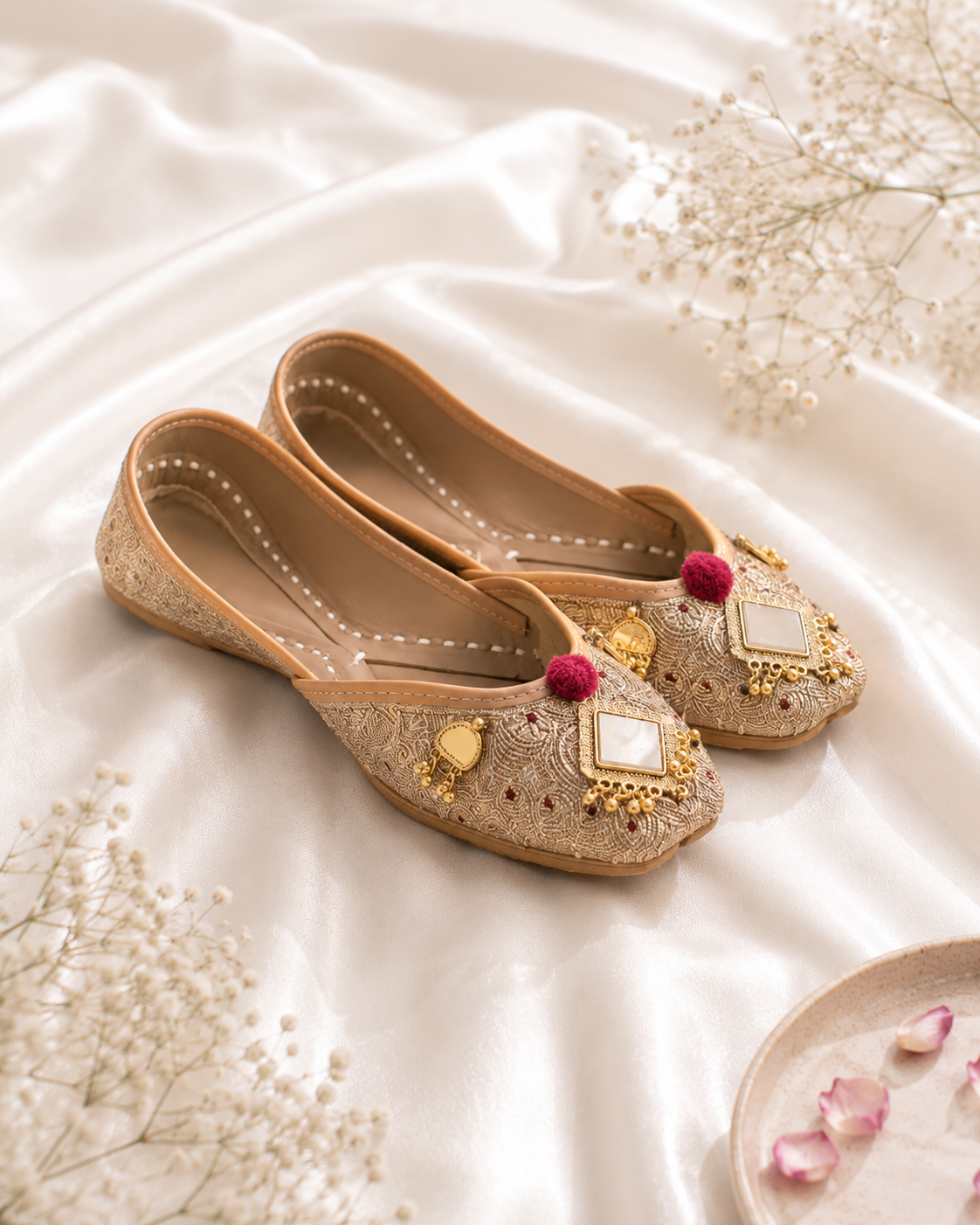 Traditional beige mojari with red pom-poms