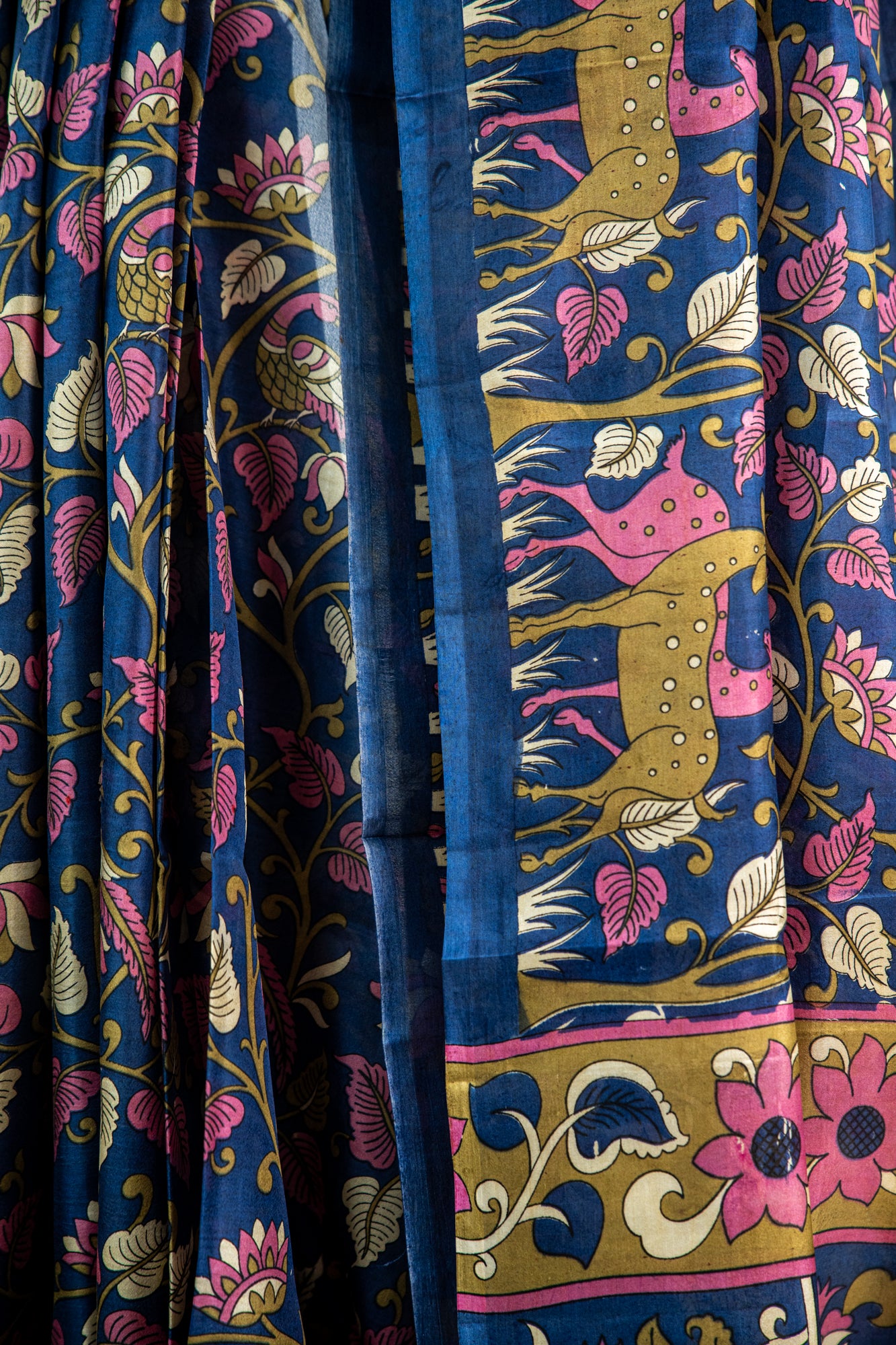 Royal Midnight Blue base adorned with Sage Green, Cream, and soft Coral Pink Pure Silk Saree
