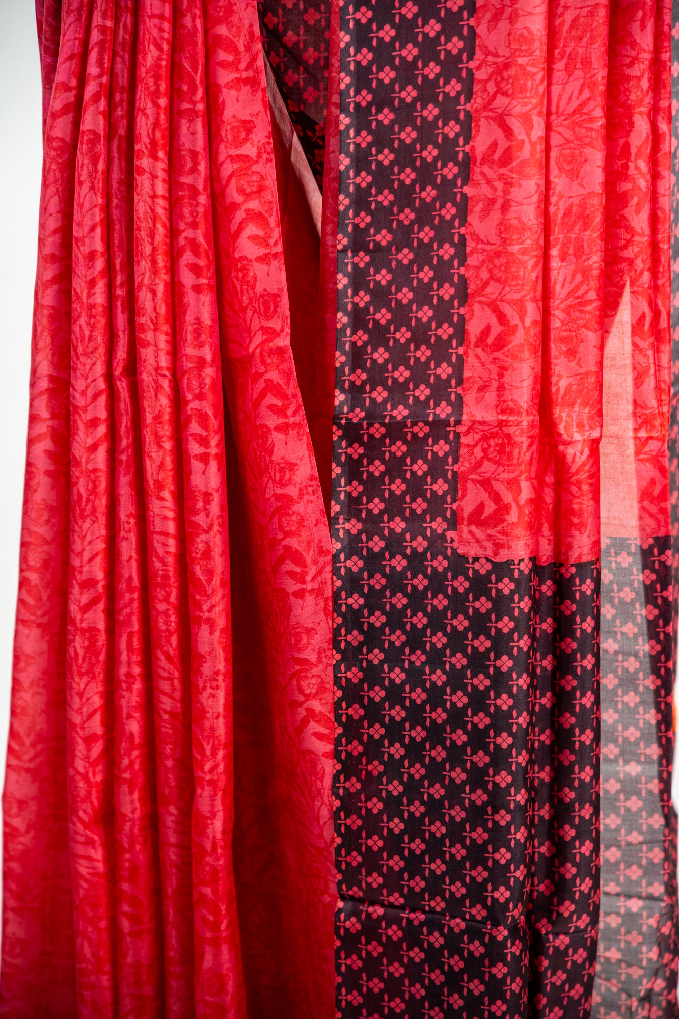Crimson Red body with a solid Jet Black border Pure Silk Saree