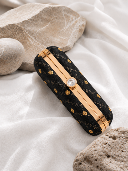 black brocade clutch bag with floral butti patterns, detachable gold chain, and metallic frame for festive and party wear